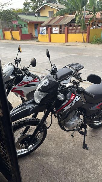 Two Honda XR 150s parked, white and black