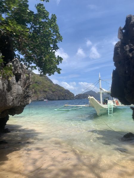 Tour boat seen through the rock gap at Hidden Beach