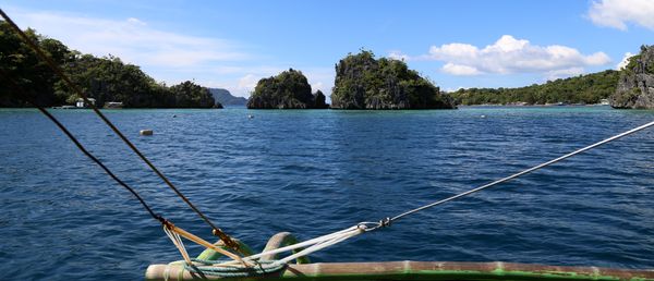 Wide view across Coron Bay toward the Siete Pecados islets, with marine park mooring buoys on the water
