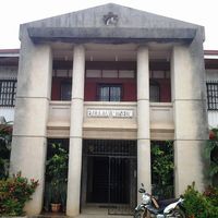 Facade of the Palawan Museum, a two-storey colonnaded building with its name on a sign above the entrance