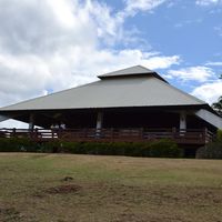 The open-sided villa pavilion at Mitra's Ranch, seen across the lawn under a blue sky